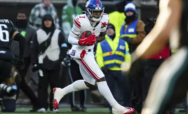 New York Giants wide receiver Malik Nabers (1) catches the ball before scoring a touchdown during the second half of an NFL football game against the Philadelphia Eagles on Sunday, Jan. 5, 2025, in Philadelphia. (AP Photo/Derik Hamilton)