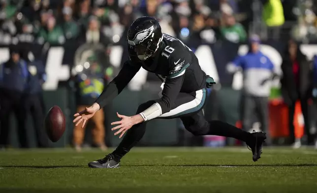 Philadelphia Eagles quarterback Tanner McKee chases a loose snap during the first half of an NFL football game against the New York Giants on Sunday, Jan. 5, 2025, in Philadelphia. (AP Photo/Matt Slocum)