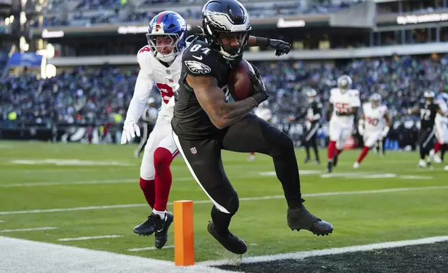 Philadelphia Eagles tight end E.J. Jenkins (84) scores a touchdown past New York Giants safety Dane Belton (24) during the second half of an NFL football game Sunday, Jan. 5, 2025, in Philadelphia. (AP Photo/Derik Hamilton)