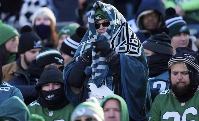 A Philadelphia Eagles' fan watches action during the second half of an NFL football game between the Eagles and the New York Giants Sunday, Jan. 5, 2025, in Philadelphia. (AP Photo/Chris Szagola)