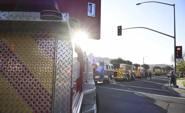 Emergency vehicles are lined up near the site of a plane crash, Thursday, Jan. 2, 2025, in Fullerton, Calif. (AP Photo/Kyusung Gong)