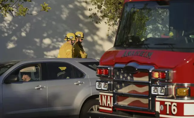 Firefighter stage outside a building where a plane crash occurred Thursday, Jan. 2, 2025, in Fullerton, Calif. (AP Photo/Kyusung Gong)