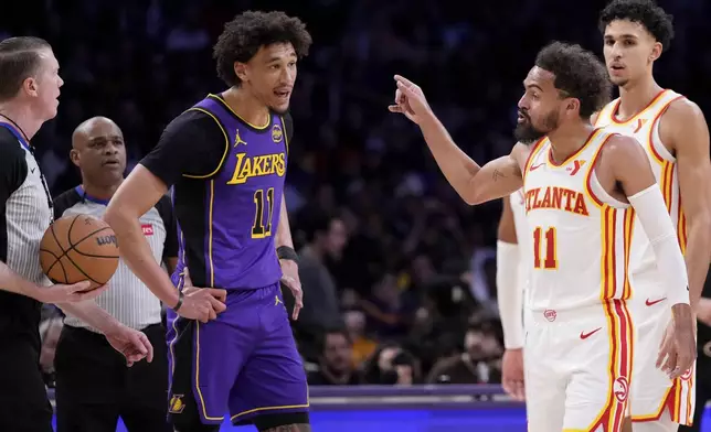 Los Angeles Lakers center Jaxson Hayes, center, jaws at Atlanta Hawks guard Trae Young, second from right, as Young complains to a referee during the first half of an NBA basketball game, Friday, Jan. 3, 2025, in Los Angeles. (AP Photo/Mark J. Terrill)