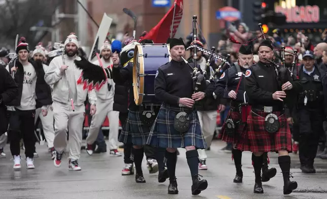 The Chicago Blackhawks arrive for the NHL Winter Classic outdoor hockey game between the Blackhawks and St. Louis Blues at Wrigley Field, Tuesday, Dec. 31, 2024, in Chicago. (AP Photo/Erin Hooley)