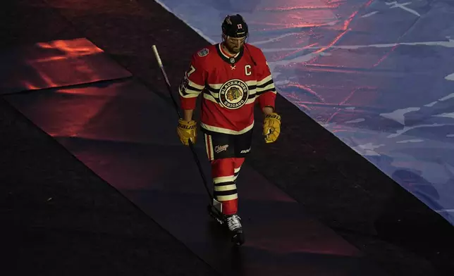 Chicago Blackhawks left wing Nick Foligno (17) takes the ice for the NHL Winter Classic outdoor hockey game featuring the Blackhawks and St. Louis Blues at Wrigley Field, Tuesday, Dec. 31, 2024, in Chicago. (AP Photo/Erin Hooley)