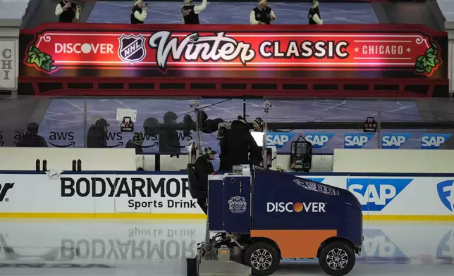 The zamboni clears the ice before the NHL Winter Classic outdoor hockey game featuring the Chicago Blackhawks and St. Louis Blues at Wrigley Field, Tuesday, Dec. 31, 2024, in Chicago. (AP Photo/Erin Hooley)