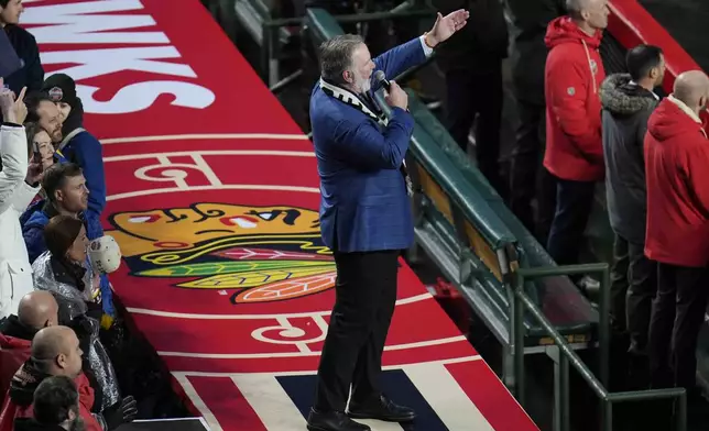 Chicago Blackhawks national anthem singer Jim Cornelison sings the Star-Spangled banner before the NHL Winter Classic outdoor hockey game featuring the Blackhawks and St. Louis Blues at Wrigley Field, Tuesday, Dec. 31, 2024, in Chicago. (AP Photo/Erin Hooley)