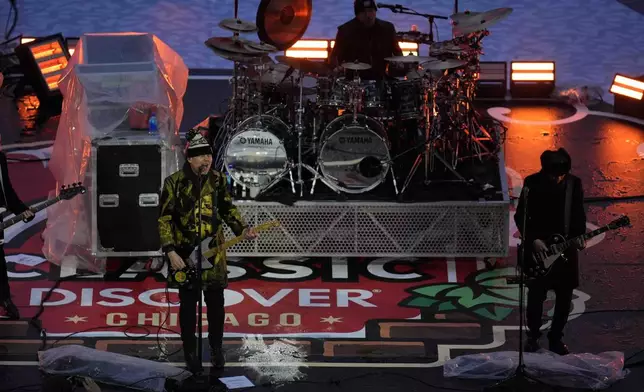 The Smashing Pumpkins perform before the NHL Winter Classic outdoor hockey game featuring the Chicago Blackhawks and St. Louis Blues at Wrigley Field, Tuesday, Dec. 31, 2024, in Chicago. (AP Photo/Erin Hooley)