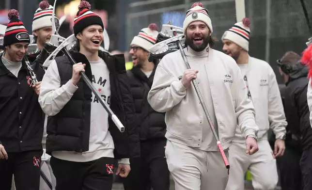 Chicago Blackhawks left wing Lukas Reichel, left, and left wing Patrick Maroon arrive with the team for the NHL Winter Classic outdoor hockey game featuring the Blackhawks and St. Louis Blues at Wrigley Field, Tuesday, Dec. 31, 2024, in Chicago. (AP Photo/Erin Hooley)