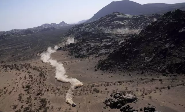 A car drives during the third stage of the Dakar Rally between Bisha and Al-Henakiyah, Saudi Arabia, Tuesday, Jan. 7, 2025. (AP Photo/Christophe Ena)