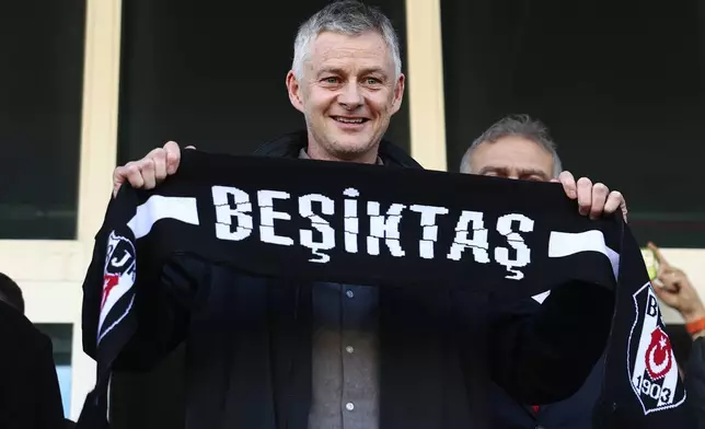 Ole Gunnar Solskjaer holds a Besiktas scarf after being appointed head coach of the Turkish soccer team, outside the Besiktas Sports Club headquarters in Istanbul, Turkey, on Friday, Jan. 17, 2025. (Saycan Sayim/DIA Photo via AP)