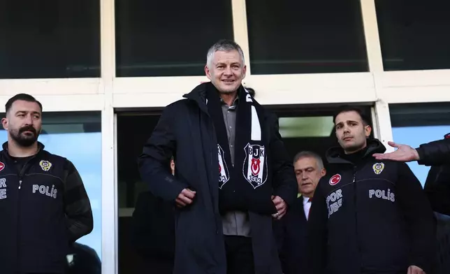 Ole Gunnar Solskjaer wears a Besiktas scarf after being appointed head coach of the Turkish soccer team, outside the Besiktas Sports Club headquarters in Istanbul, Turkey, on Friday, Jan. 17, 2025. (Saycan Sayim/DIA Photo via AP)