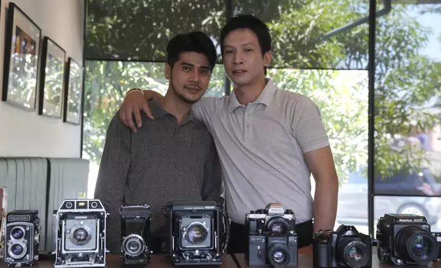Pitee Chuchomchuen, 39, designer, left, and Prorawin Battemdee, 40, public relations officer, pose for a photograph in Bangkok, Thailand, Saturday, Jan. 11, 2025. (AP Photo/Sakchai Lalit)