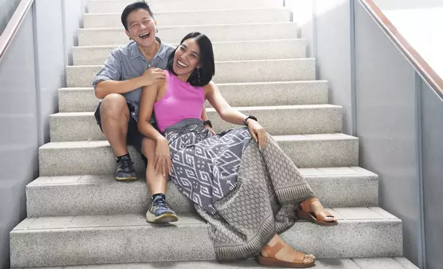 Chantamas Hemapanpairo, 52, business owner, and Sirada Thongchua, 38, teacher, pose for a portrait in Bangkok, Thailand, Sunday, Jan. 12, 2025. (AP Photo/Sakchai Lalit)