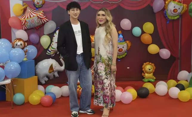 Panuwat Srisawat, 35, hair creative, left, and Kritsanai Promsiriruk, 62, actor, stand for a portrait in Bangkok, Thailand, Sunday, Jan. 12, 2025. (AP Photo/Sakchai Lalit)