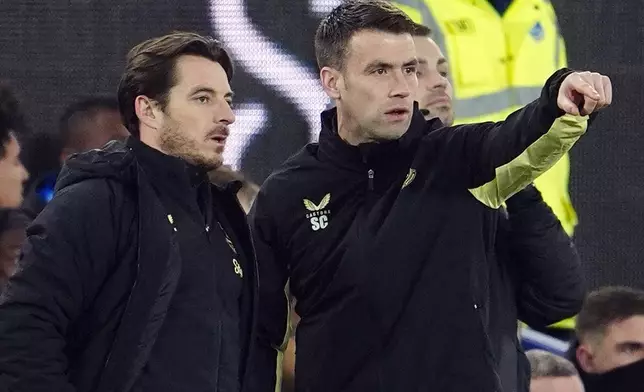 Everton caretaker managers Leighton Baines, left, and Seamus Coleman consult on the touchline during the English FA Cup third round soccer match between Everton and Peterborough United at Goodison Park, Liverpool, England, Thursday Jan. 9, 2025. (Peter Byrne/PA via AP)