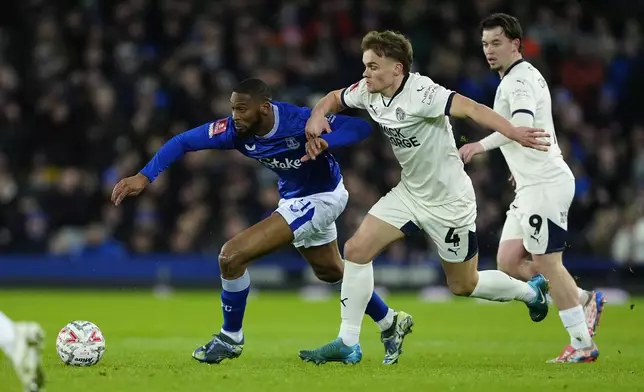 Everton's Beto, left, and Peterborough United's Archie Collins battle for the ball during the English FA Cup third round soccer match between Everton and Peterborough United at Goodison Park, Liverpool, England, Thursday Jan. 9, 2025. (Peter Byrne/PA via AP)