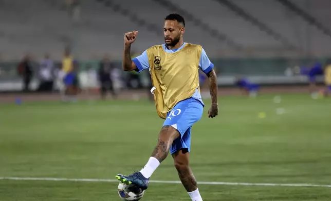FILE - Al Hilal's Neymar shoots the ball during warm up for the AFC Champions League soccer match against Iran's Nassaji at the Azadi Stadium in Tehran, Iran, Oct. 3, 2023. (AP Photo, File)