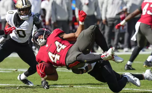 Tampa Bay Buccaneers Sean Tucker (44) is stopped by New Orleans Saints safety Millard Bradford on a kickoff return during the first half of an NFL football game Sunday, Jan. 5, 2025, in Tampa, Fla. (AP Photo/Chris O'Meara)