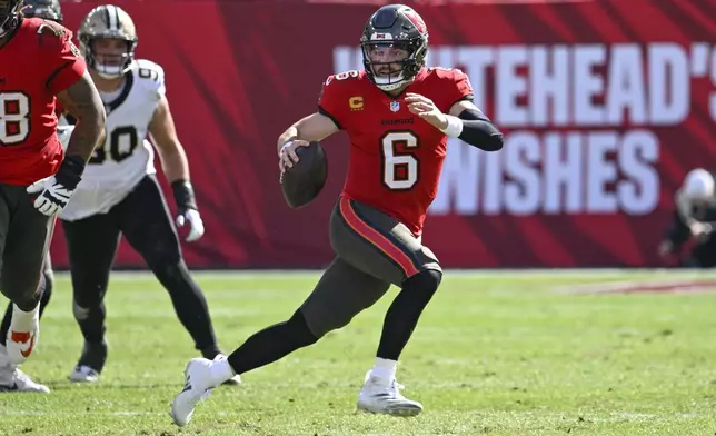 Tampa Bay Buccaneers quarterback Baker Mayfield (6) scrambles during the first half of an NFL football game against the New Orleans Saints Sunday, Jan. 5, 2025, in Tampa, Fla. (AP Photo/Jason Behnken)