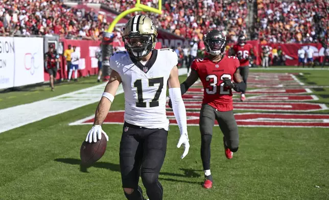 New Orleans Saints wide receiver Dante Pettis (17) pulls in a touchdown reception during the first half of an NFL football game against the Tampa Bay Buccaneers Sunday, Jan. 5, 2025, in Tampa, Fla. (AP Photo/Jason Behnken)