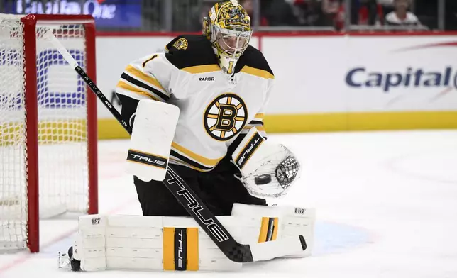 Boston Bruins goaltender Jeremy Swayman (1) tracks the puck during the first period of an NHL hockey game against the Washington Capitals, Tuesday, Dec. 31, 2024, in Washington. (AP Photo/Nick Wass)