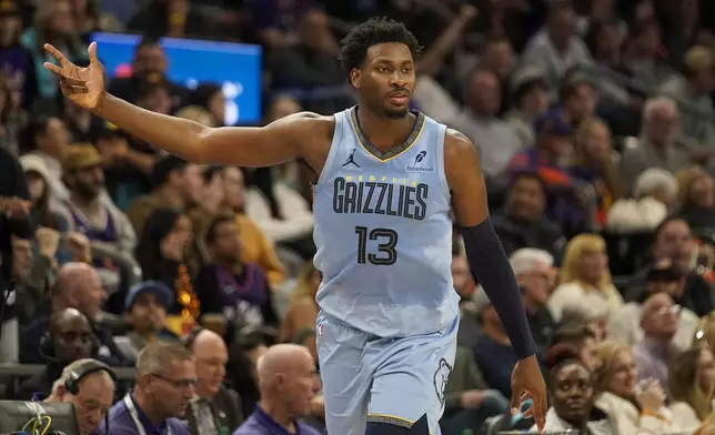 Memphis Grizzlies forward Jaren Jackson Jr. (13) celebrates hitting a 3-pointer during the second half of an NBA basketball game against the Phoenix Suns Tuesday, Dec. 31, 2024, in Phoenix. Memphis won 117-112. (AP Photo/Darryl Webb)