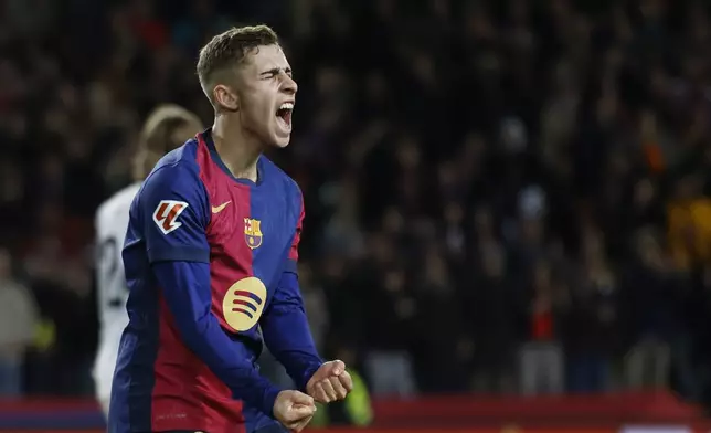 Barcelona's Fermin Lopez celebrates after Robert Lewandowski scored their side's sixth goal during the Spanish La Liga soccer match between Barcelona and Valencia at the Lluis Companys Olympic Stadium in Barcelona, Spain, Sunday, Jan. 26, 2025. (AP Photo/Joan Monfort)