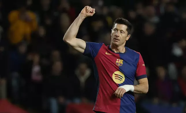 Barcelona's Robert Lewandowski celebrates after scoring his side's sixth goal during the Spanish La Liga soccer match between Barcelona and Valencia at the Lluis Companys Olympic Stadium in Barcelona, Spain, Sunday, Jan. 26, 2025. (AP Photo/Joan Monfort)