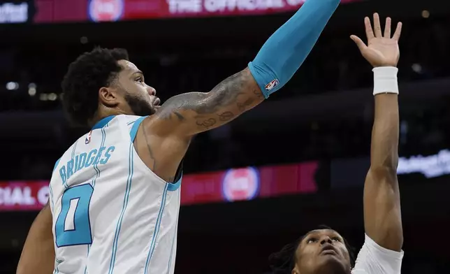 Charlotte Hornets forward Miles Bridges (0) goes to the basket against Detroit Pistons forward Ausar Thompson (9) during the first half of an NBA basketball game Friday, Jan. 3, 2025, in Detroit. (AP Photo/Duane Burleson)