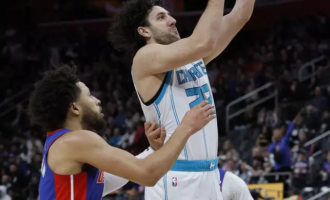 Charlotte Hornets guard Vasilije Micic (22) goes to the basket past Detroit Pistons guard Cade Cunningham, left, during the first half of an NBA basketball game Friday, Jan. 3, 2025, in Detroit. (AP Photo/Duane Burleson)