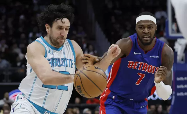 Charlotte Hornets guard Vasilije Micic (22) drives to the basket against Detroit Pistons forward Paul Reed (7) during the first half of an NBA basketball game Friday, Jan. 3, 2025, in Detroit. (AP Photo/Duane Burleson)