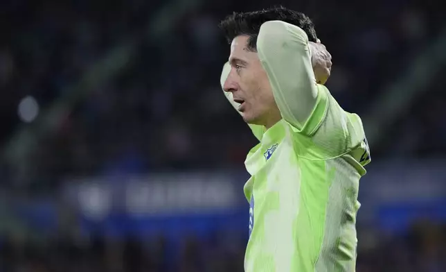 Barcelona's Robert Lewandowski reacts after missing a chance to score against Getafe during a Spanish La Liga soccer match at the Coliseum Alfonso Perez stadium in Getafe, Spain, Saturday, Jan. 18, 2025. (AP Photo/Manu Fernandez)