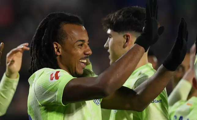 Barcelona's Jules Kounde celebrates after scoring the opening goal against Getafe during a Spanish La Liga soccer match at the Coliseum Alfonso Perez stadium in Getafe, Spain, Saturday, Jan. 18, 2025. (AP Photo/Manu Fernandez)