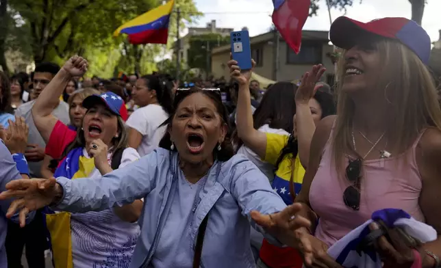 Supporters of Venezuela's opposition leader Edmundo Gonzalez Urrutia react as he walks outside the government residence in Montevideo, Uruguay, Saturday, Jan. 4, 2025. Gonzalez, who claims he won the 2024 presidential election and is recognized by some countries as the legitimate president-elect, traveled from exile in Madrid to Argentina and Uruguay. (AP Photo/Matilde Campodonico)