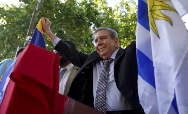 Venezuela's opposition leader Edmundo Gonzalez Urrutia holds an Uruguayan and a Venezuelan flag outside the government residence in Montevideo, Uruguay, Saturday, Jan. 4, 2025. Gonzalez, who claims he won the 2024 presidential election and is recognized by some countries as the legitimate president-elect, traveled from exile in Madrid to Argentina and Uruguay. (AP Photo/Matilde Campodonico)