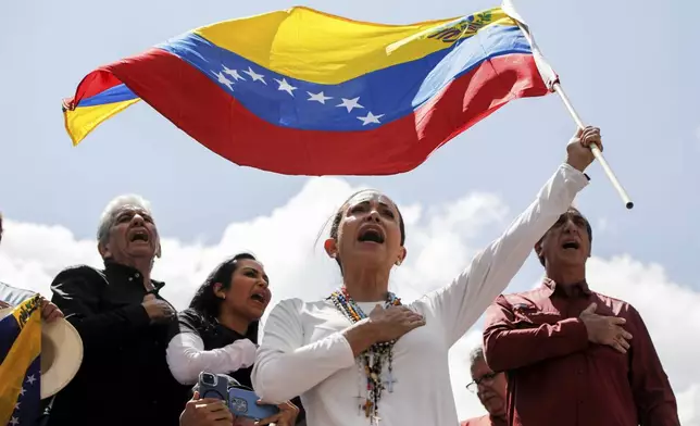 FILE - Opposition leader Maria Corina Machado waves a Venezuelan national flag during a rally to protest official results that declared President Nicolas Maduro the winner of the July presidential election, in Caracas, Venezuela, Aug. 17, 2024. (AP Photo/Cristian Hernandez, File)