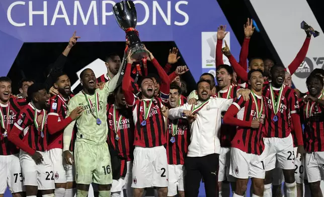 AC Milan's team celebrates after winning the Italian Super Cup final soccer match between AC Milan and Inter Milan at Al Awwal Park Stadium in Riyadh, Saudi Arabia, Monday, Jan. 6, 2025. (AP Photo/Altaf Qadri)