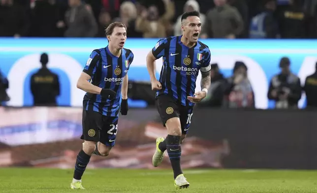 Inter Milan's Lautaro Martinez, right, celebrates after scoring his side's first goal during the Italian Super Cup final soccer match between AC Milan and Inter Milan at Al Awwal Park Stadium in Riyadh, Saudi Arabia, Monday, Jan. 6, 2025. (Massimo Paolone/LaPresse via AP)