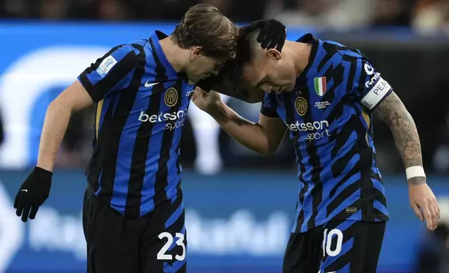 Inter Milan's Lautaro Martinez celebrates with Inter Milan's Nicolo Barella, left, after scoring his sides first goal during the Italian Super Cup final soccer match between AC Milan and Inter Milan at Al Awwal Park Stadium in Riyadh, Saudi Arabia, Monday, Jan. 6, 2025. (AP Photo/Altaf Qadri)