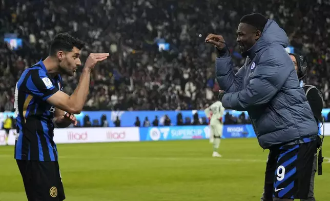 Inter Milan's Mehdi Taremi, left, celebrates with Inter Milan's Marcus Thuram after scoring his sides second goal during the Italian Super Cup final soccer match between AC Milan and Inter Milan at Al Awwal Park Stadium in Riyadh, Saudi Arabia, Monday, Jan. 6, 2025. (AP Photo/Altaf Qadri)