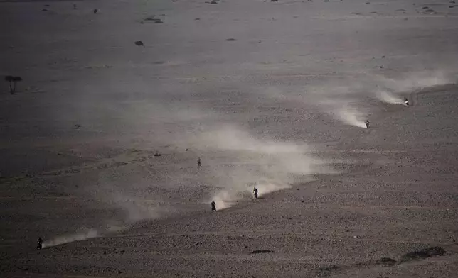 Riders compete during the ninth stage of the Dakar Rally between Riyadh and Haradh, Saudi Arabia, Tuesday, Jan. 14, 2025. (AP Photo/Christophe Ena)