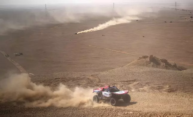 Driver Simon Vitse and co-driver Max Delfino compete during the ninth stage of the Dakar Rally between Riyadh and Haradh, Saudi Arabia, Tuesday, Jan. 14, 2025. (AP Photo/Christophe Ena)