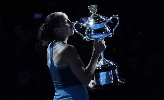 Madison Keys of the U.S. kisses the Daphne Akhurst Memorial Cup after defeating Aryna Sabalenka of Belarus in the women's singles final at the Australian Open tennis championship in Melbourne, Australia, Saturday, Jan. 25, 2025. (AP Photo/Vincent Thian)