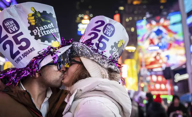 A couple kiss after the ball drops in New York's Times Square, Wednesday, Jan. 1, 2025, in New York. (AP Photo/Stefan Jeremiah)