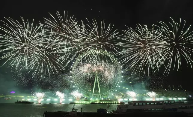 Fireworks light up the sky around the London Eye on the south bank of the River Thames to celebrate the New Year in London, Wednesday, Jan. 1, 2025. (AP Photo/Alberto Pezzali)