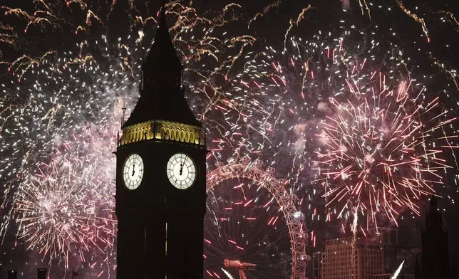 Fireworks light up the sky over Elizabeth Tower, also known as Big Ben, and the London Eye in central London during the New Year celebrations Wednesday Jan. 1, 2025. (James Manning/PA via AP)