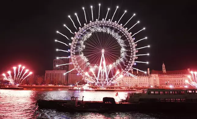 Fireworks light up the sky around the London Eye to celebrate the New Year in London, Wednesday, Jan. 1, 2025. (AP Photo/Alberto Pezzali)