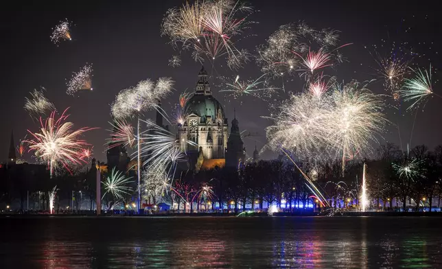 Fireworks explode in the sky above the New Town Hall on New Year's Eve in Hanover, Germany, on Jan. 1, 2025. (Moritz Frankenberg/dpa via AP)