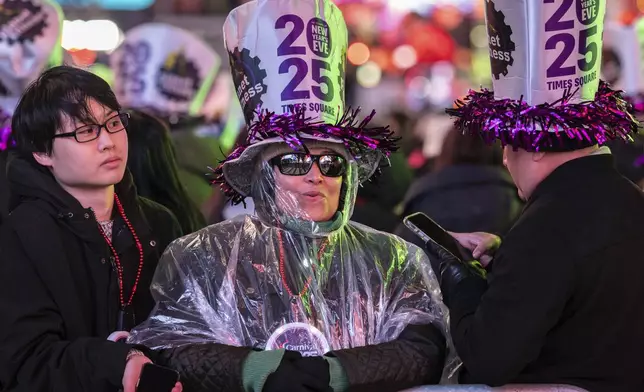 Revellers celebrate in New York's Times Square as they attend a New Year's Eve celebration, Tuesday, Dec. 31, 2024, in New York. (AP Photo/Stefan Jeremiah)